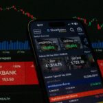 Close-up of a digital stock trading app interface with investment charts and market trends displayed.